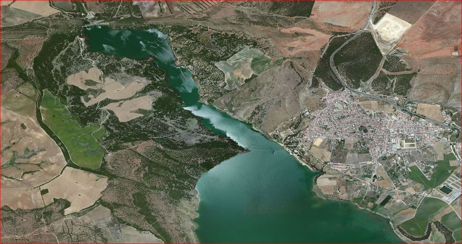 El futuro circuito de velocidad  quedaría a la izquierda de esta imagen aérea, con vistas al embalse y  donde se observa enfrente el núcleo urbano de Bornos.