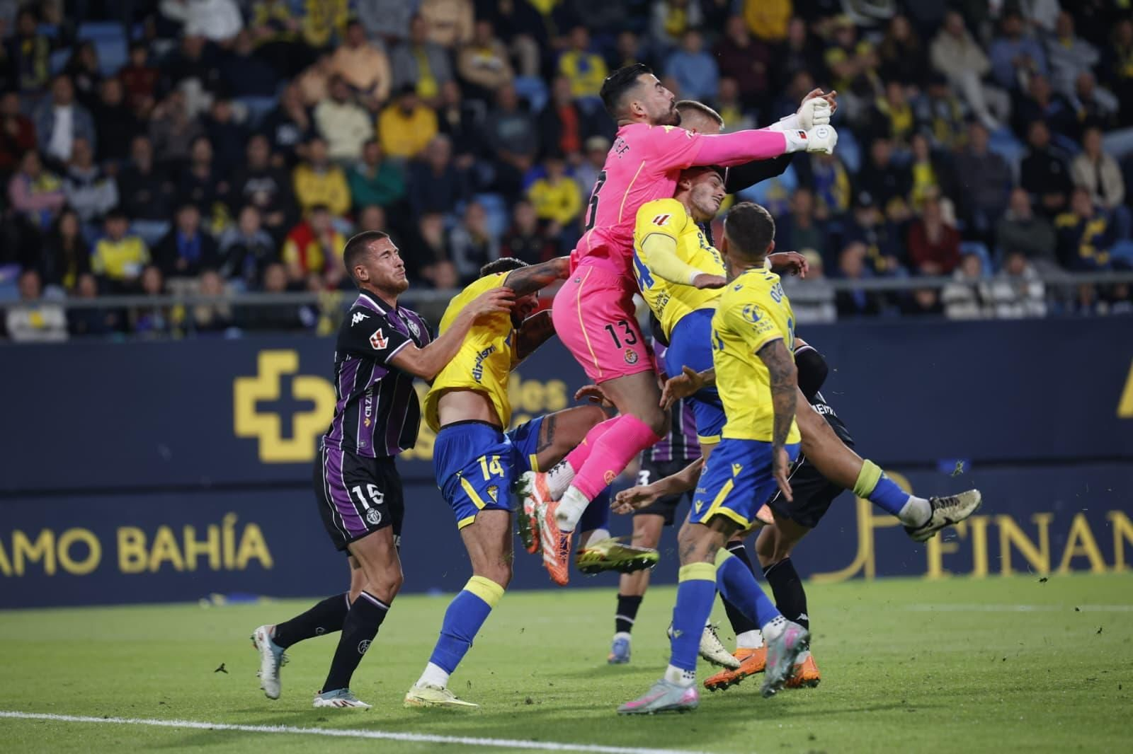 Jugadores del Cádiz saltan a por el balón a la vez que el portero del Valladolid.