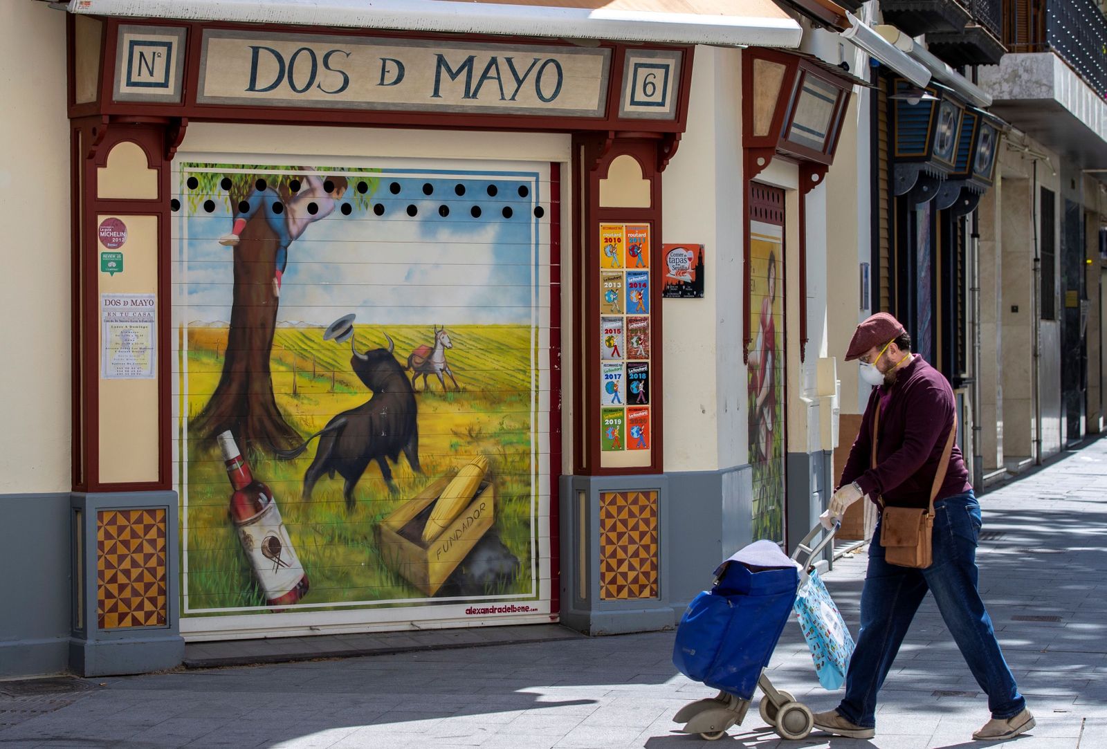 Una persona pasea con un carro de la compra por una plaza del centro de Sevilla.