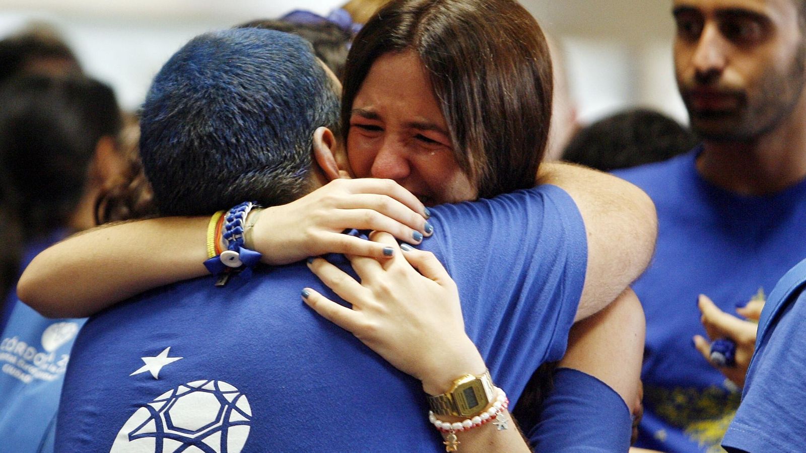 Dos personas se abrazan tras conocer el fallo del jurado de la Capitalidad en favor de San Sebastián.