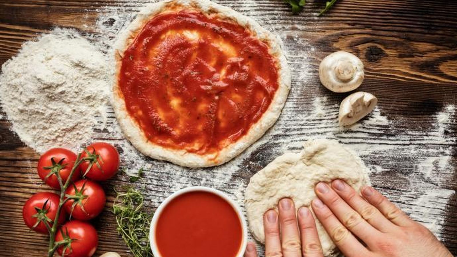 Masa de pizza y tomate eladorados artesanalmente.