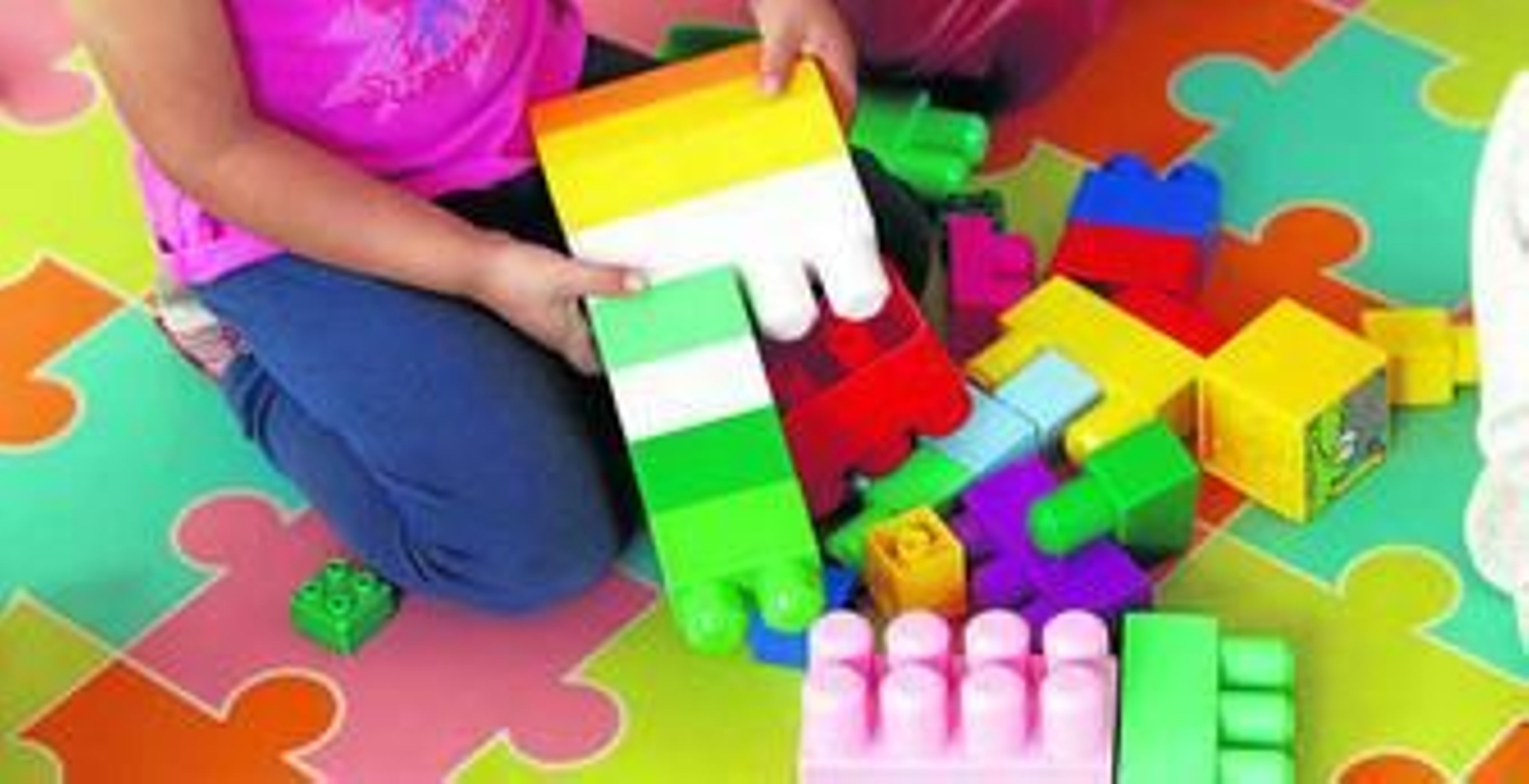 Niños juegan con piezas de construcción en una escuela infantil.