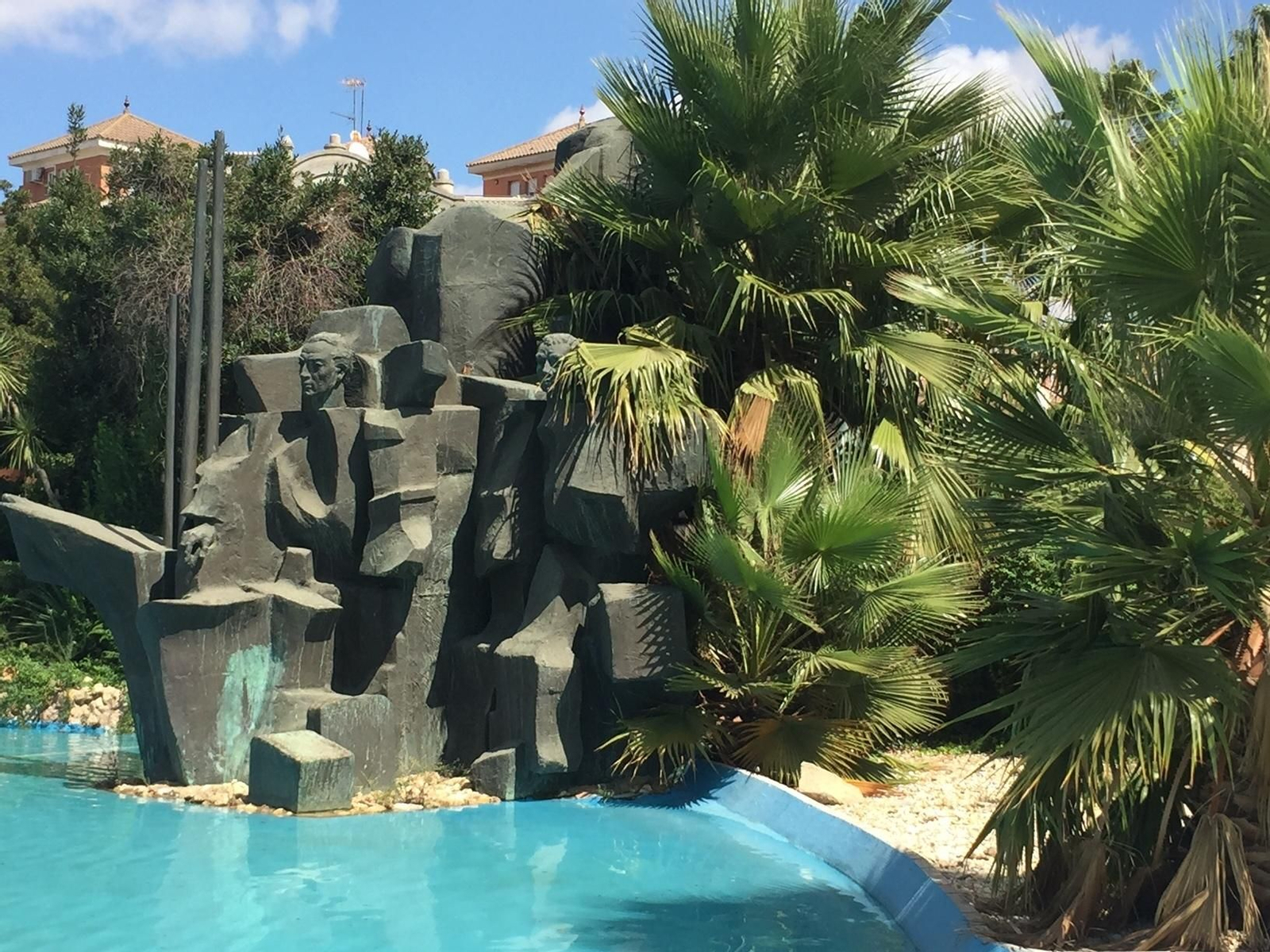 1. Aspecto actual del monumento, donde unas palmeras ocultan parte del mismo y varias figuras emblemáticas. 2. El monumento antes de ser cubierto por la vegetación. 3. La trasera está igualmente tapada.