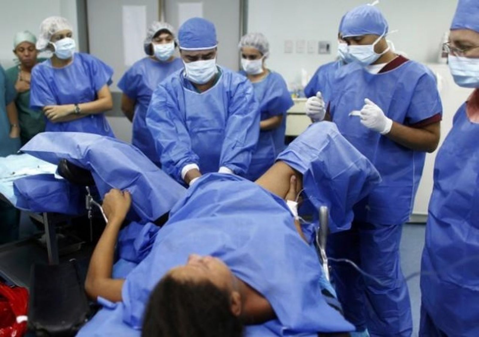 Una mujer da a luz rodeada de sanitarios