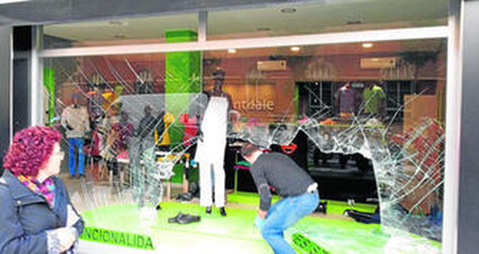 Miembros de la Policía Científica toman huellas en el comercio robado.