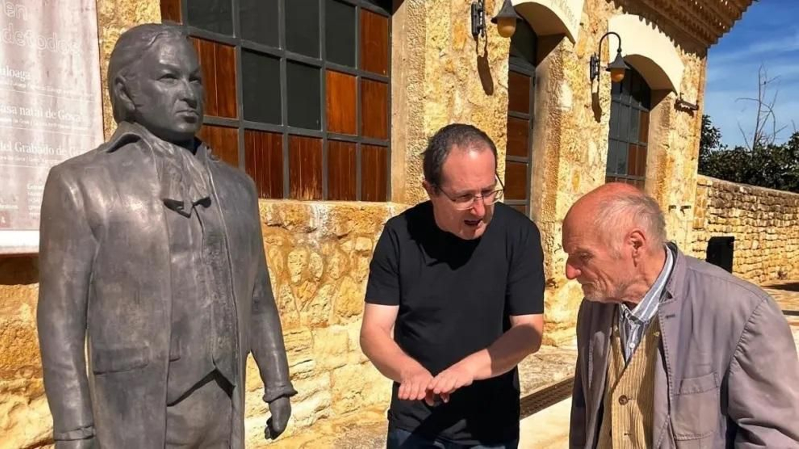 Andrés García Ibáñez y Antonio López junto a la estatua de Goya.