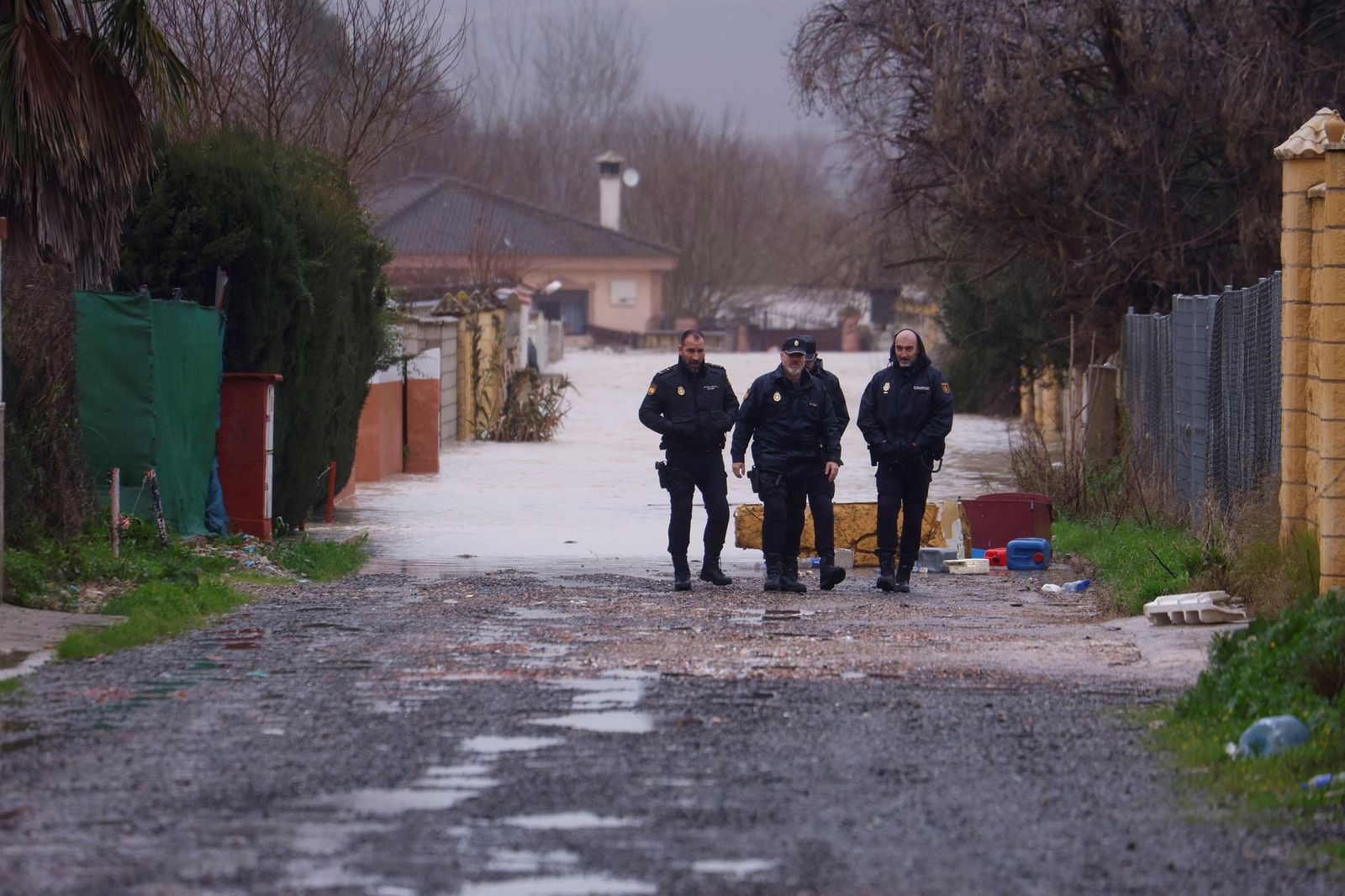 Varios policías nacionales, en la zona de Guadalvalle anegada por el Guadalquivir.