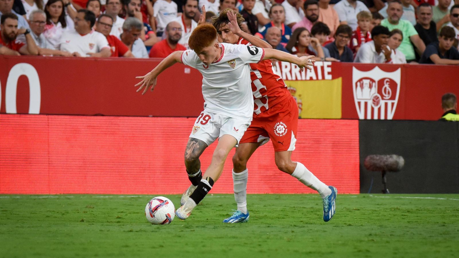 Barco pelea un balón con Bryan Gil.