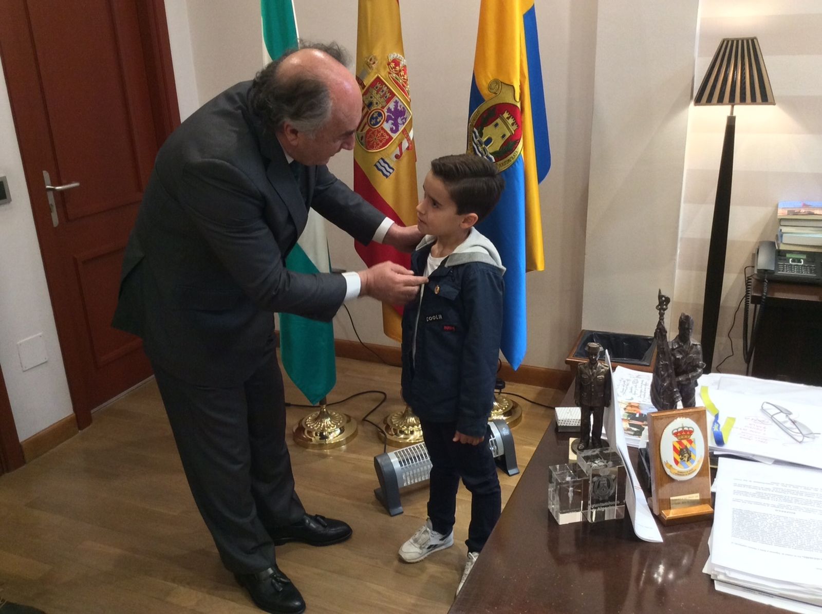 Landaluce coloca la insignia de la ciudad al niño Daniel García.