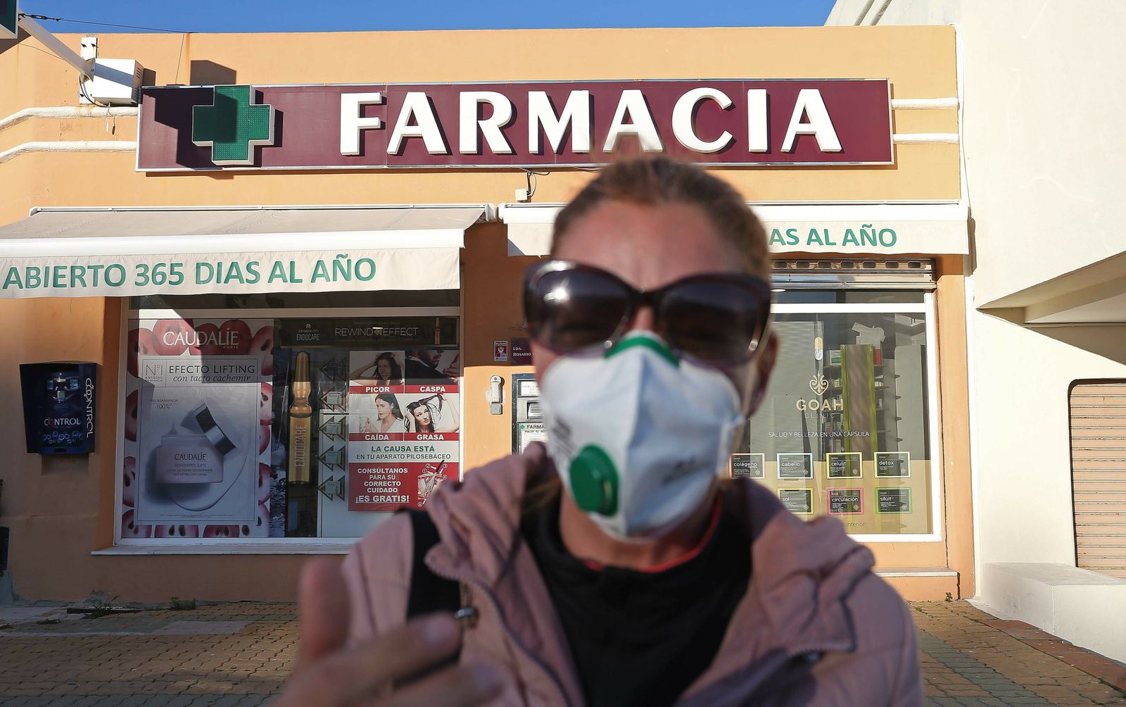 Una mujer, con una mascarilla a las puertas de una farmacia en Algeciras