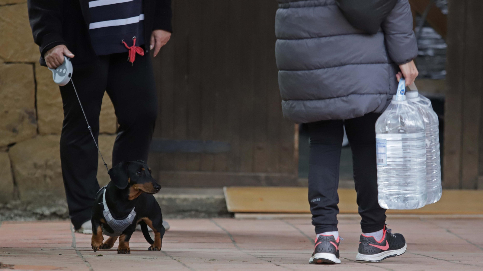 Imagen de archivo de una persona con garrafas de agua.