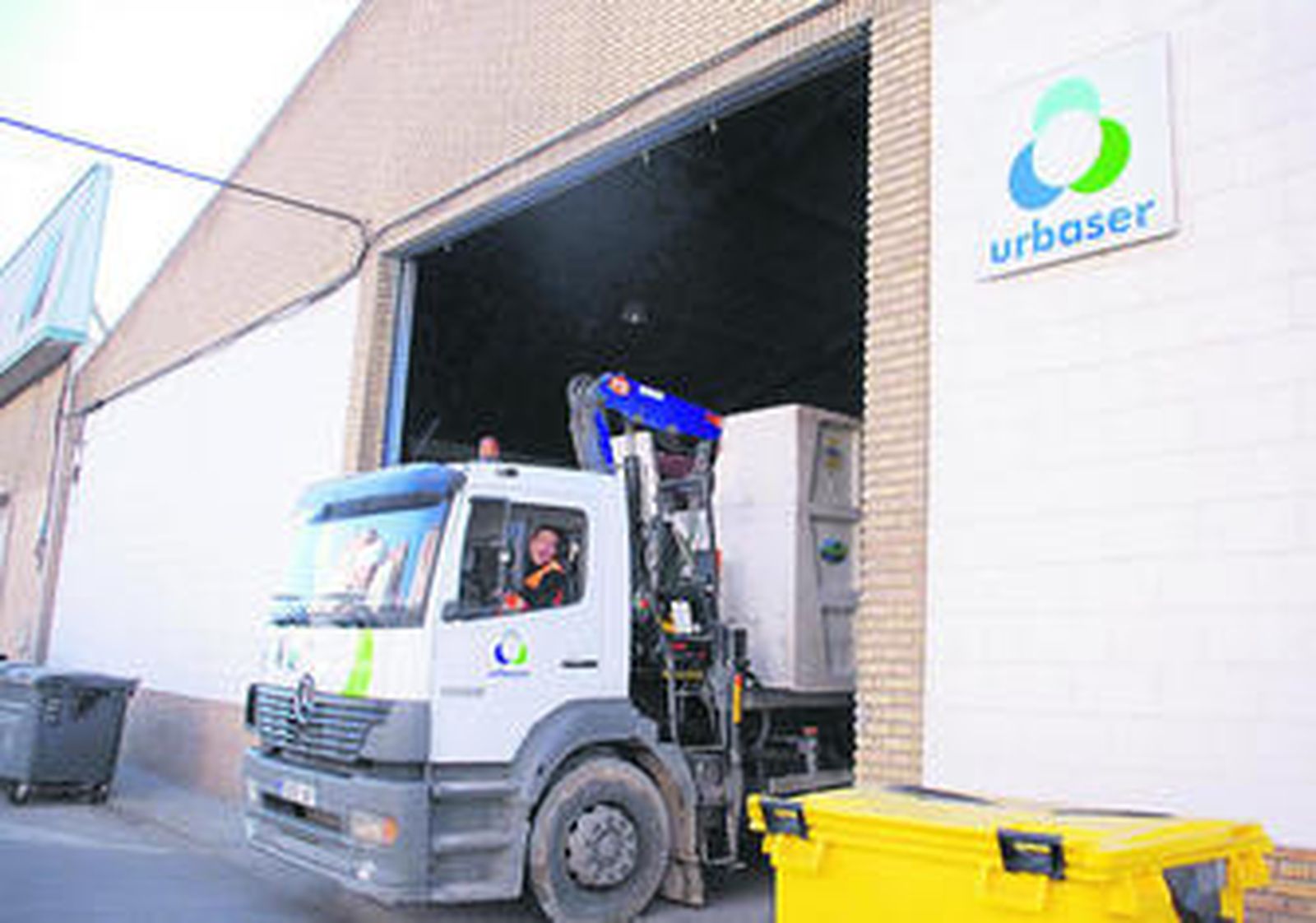 Uno de los camiones de recogida de basuras sale de la nave de Urbaser en El Torno.