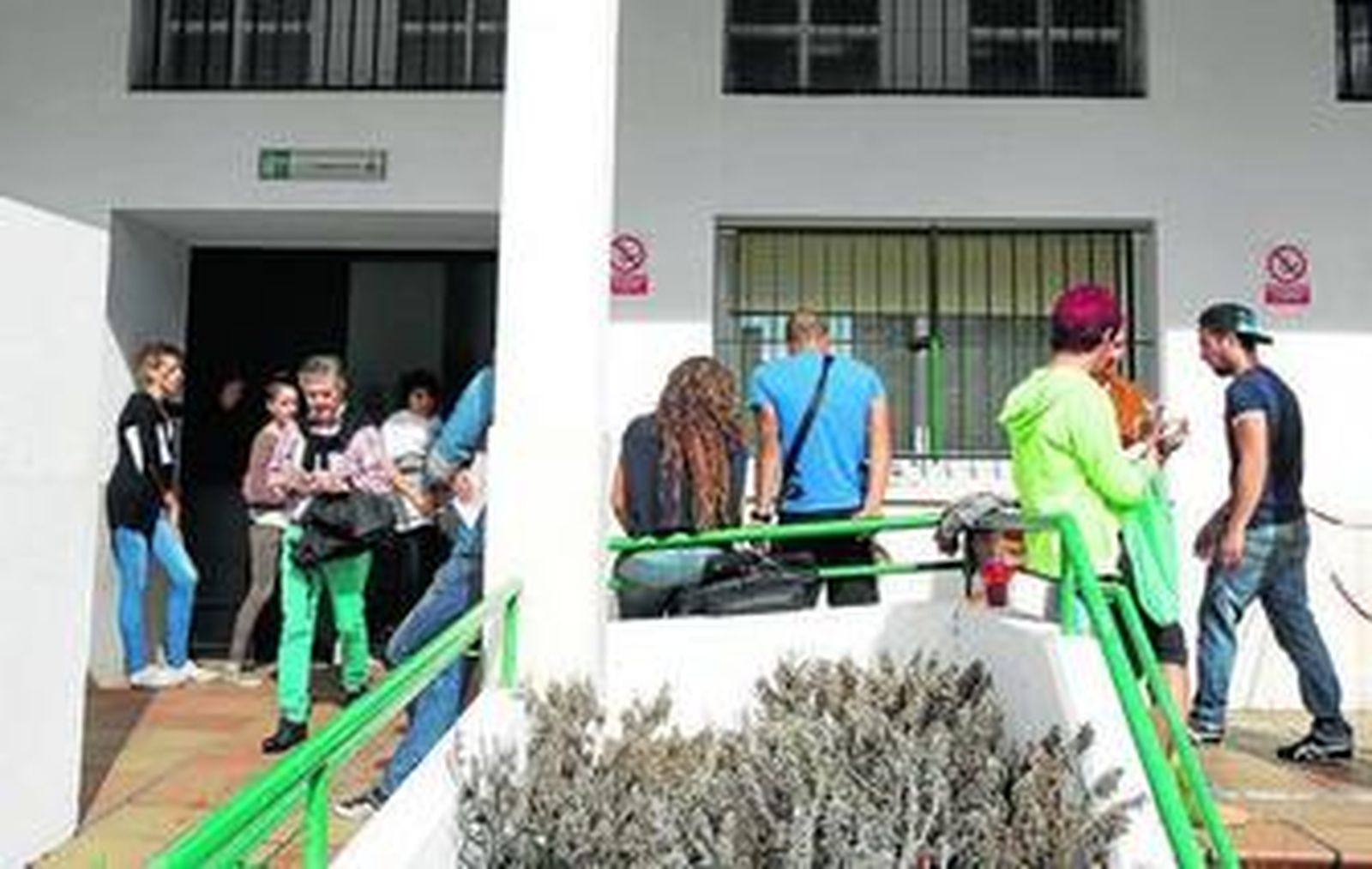 Personas esperando a las puertas del registro civil de Algeciras.