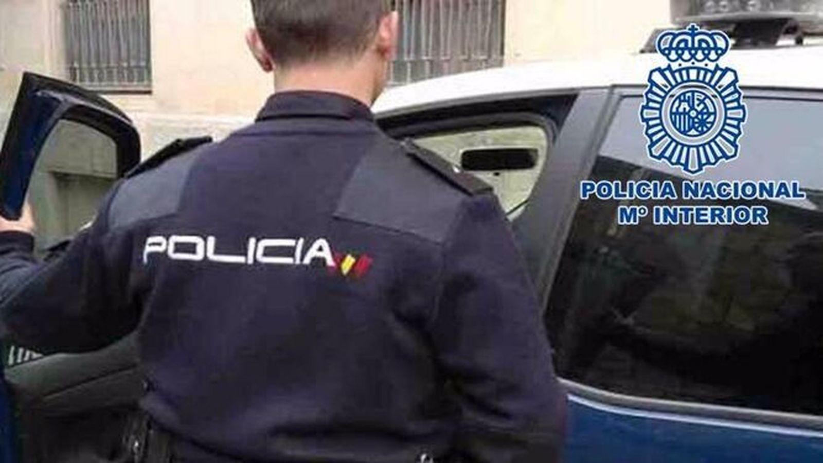 Un agente de la Policía Nacional se dispone a subir a un vehículo.