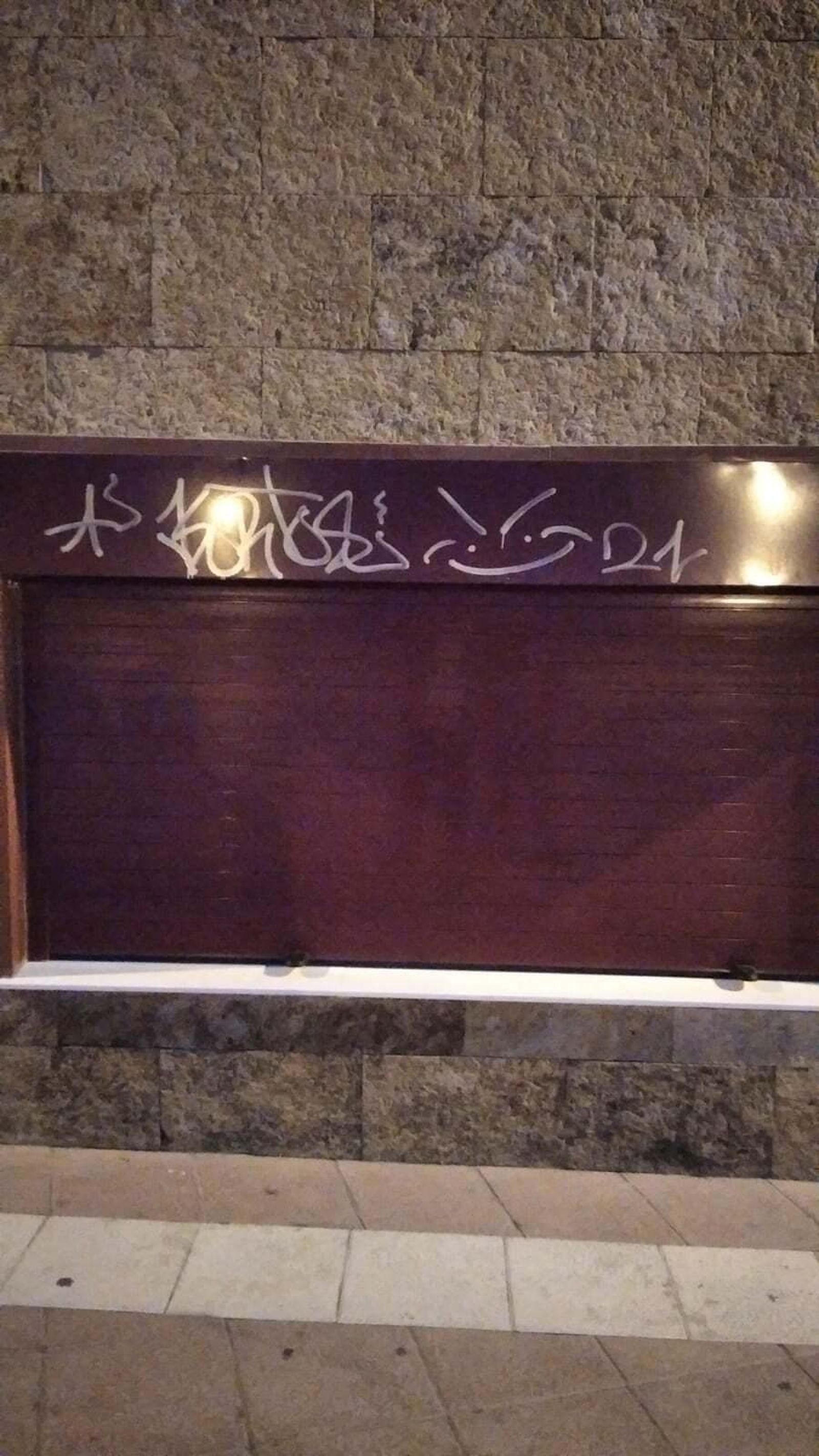 Grafitis aparecidos en la baraja recién instalada en un edificio de la primera pista de la Barrosa  por operarios municipales.