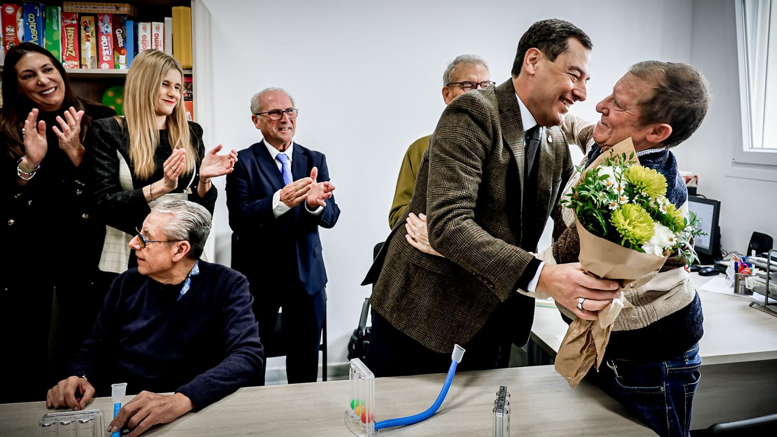 Moreno, recibiendo un ramo de flores de mano de un usuario de Parkinson Bahía de Cádiz.