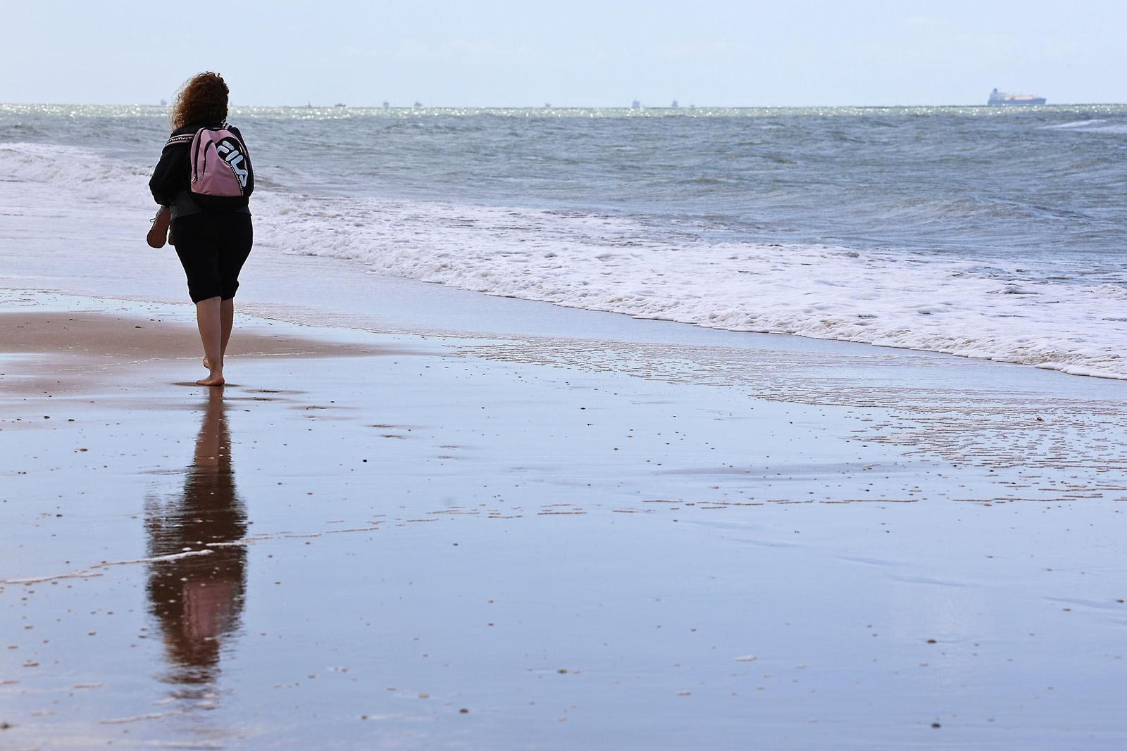 Una chica pasea por una playa de Huelva a comienzos de octubre.