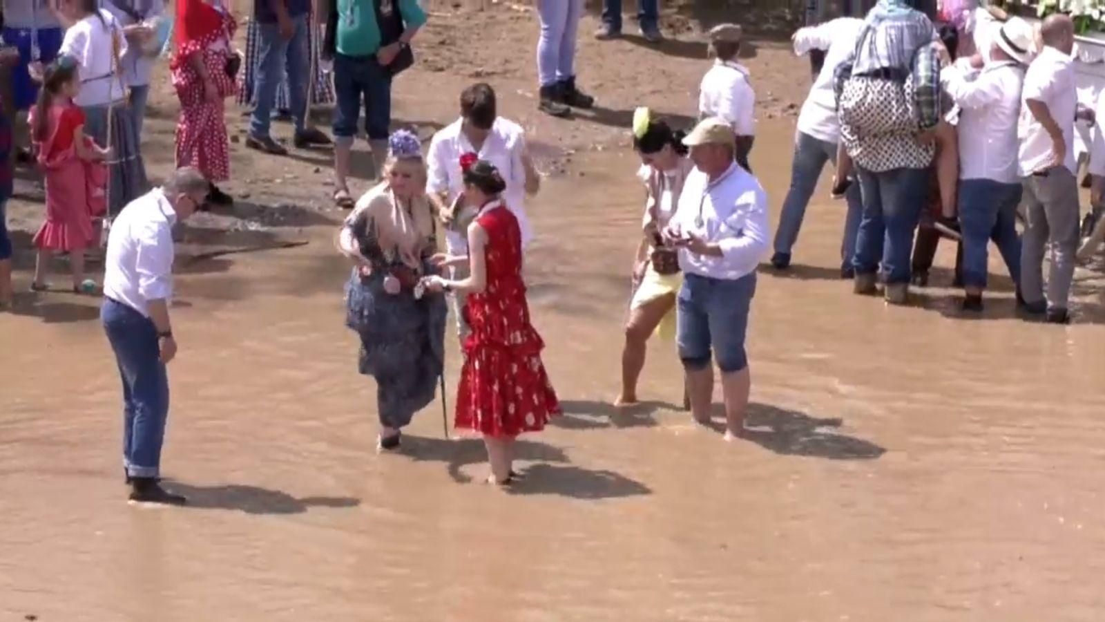 El agua cubre ya los pies de los romeros en el Vado de Quema.