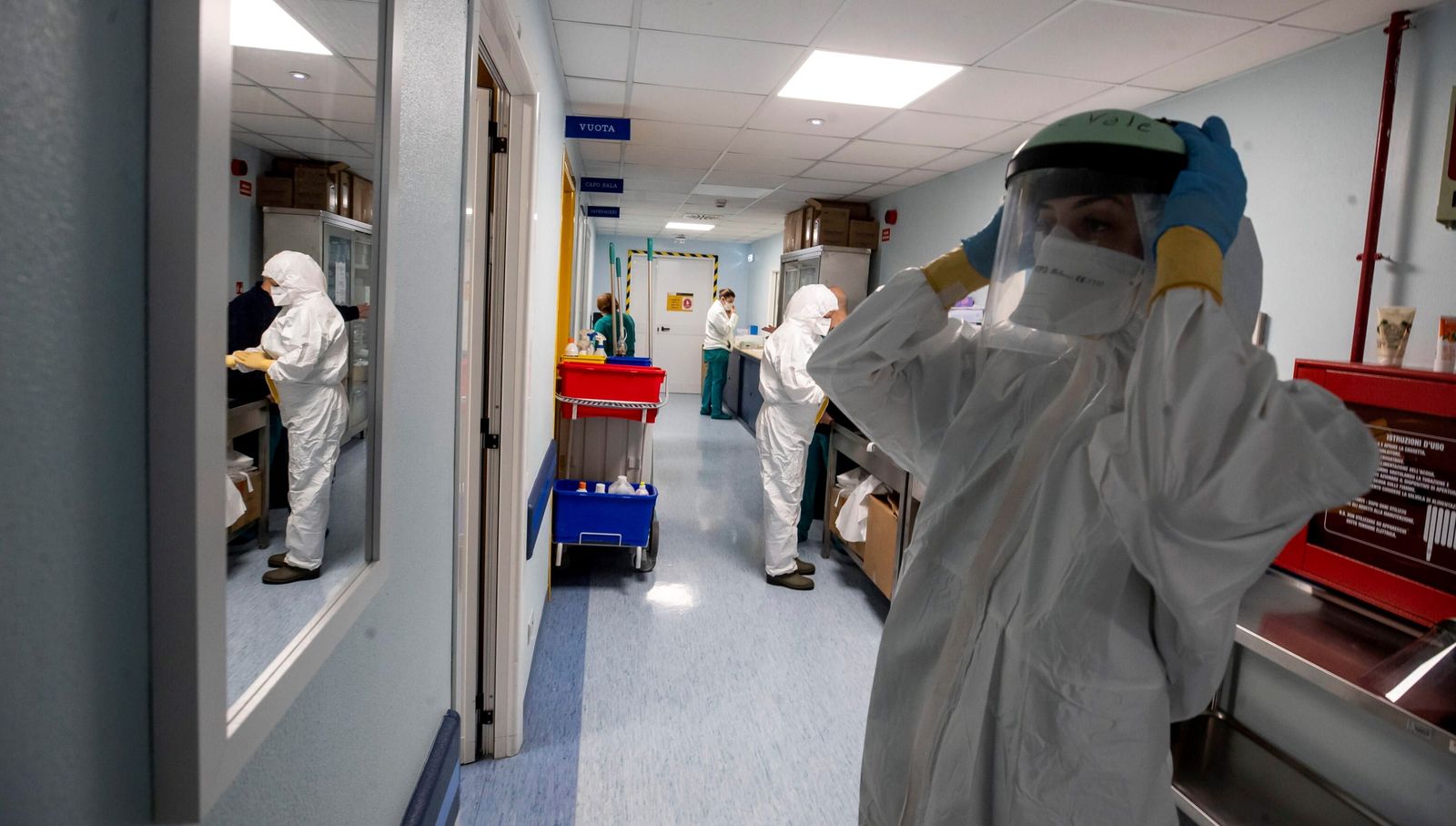 Una profesional sanitaria se prepara para entrar en una UCI.