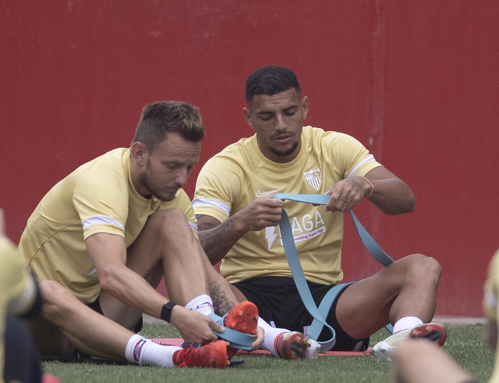 Diego Carlos y Rakitic, en un entrenamiento haciendo preventivo con bandas elásticas.