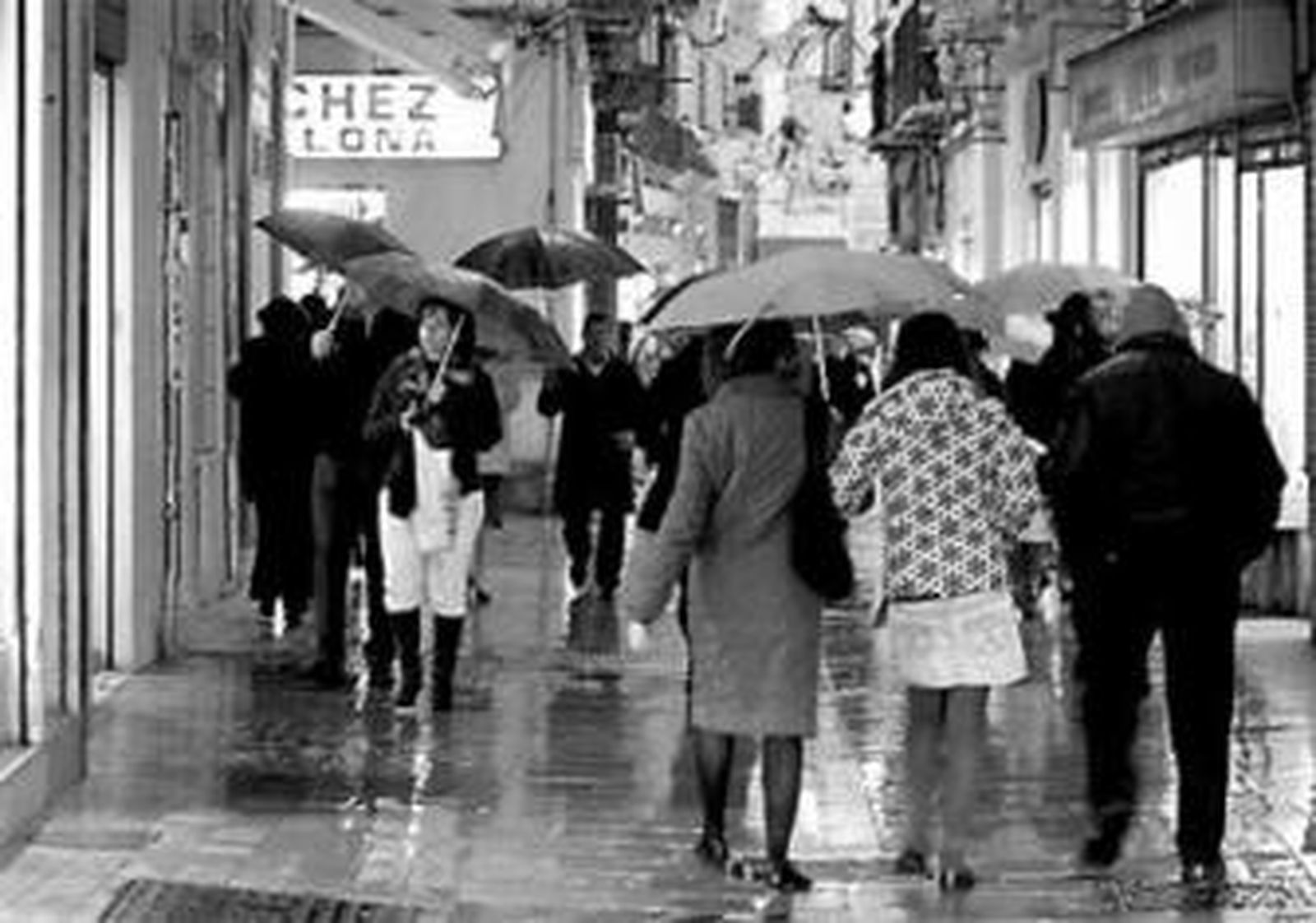 Los viandantes se protegen de la lluvia caída ayer en Málaga.