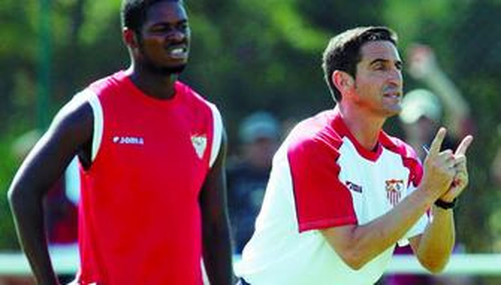 Manolo Jiménez da instrucciones durante un entrenamiento, ante la atenta mirada de Romaric.