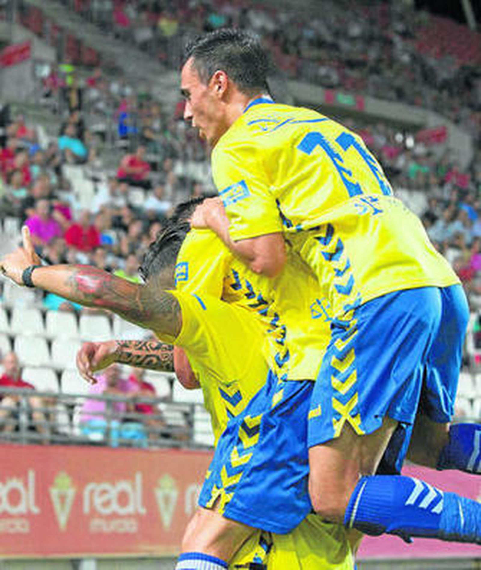 Lolo Plá y Álvaro García se suben sobre Hugo para celebrar su gol al Murcia.