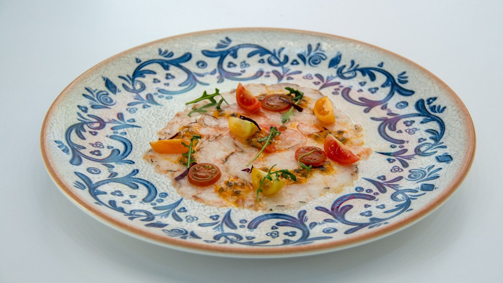 Un plato de carpaccio de quisquilla de Motril con maracuyá y cherry