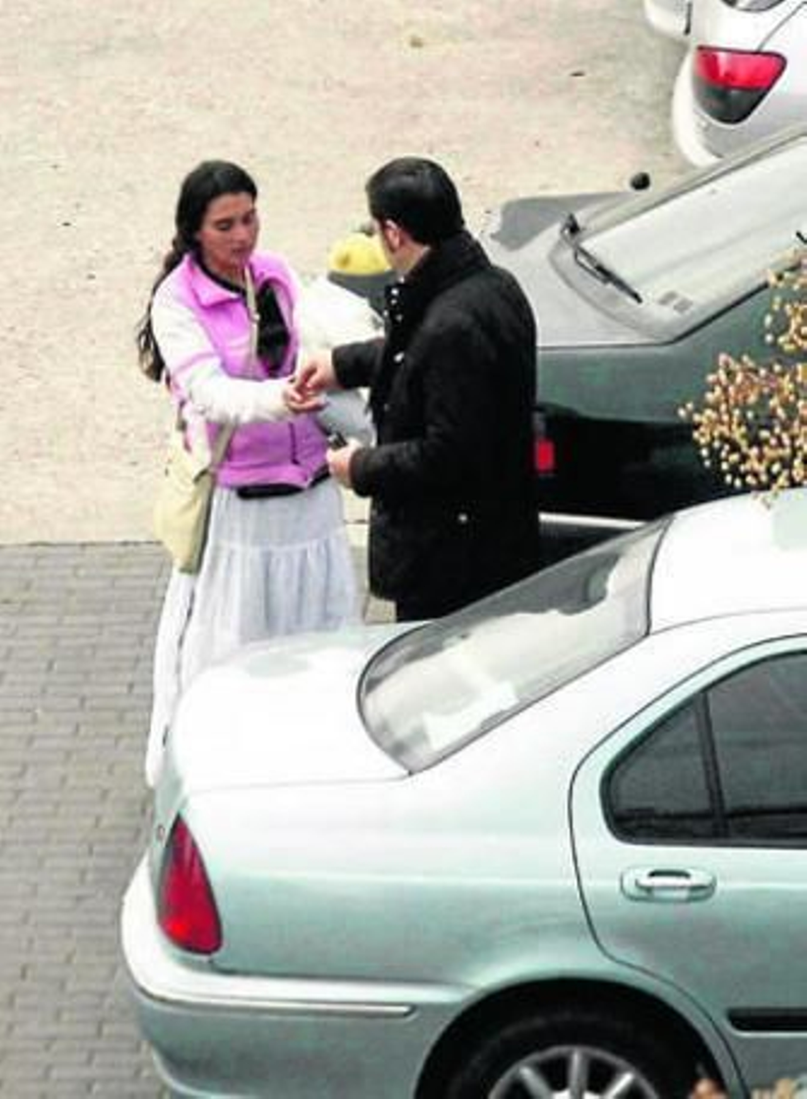 Una mujer rumana pide con un niño en brazos en un aparcamiento de la ciudad de Córdoba