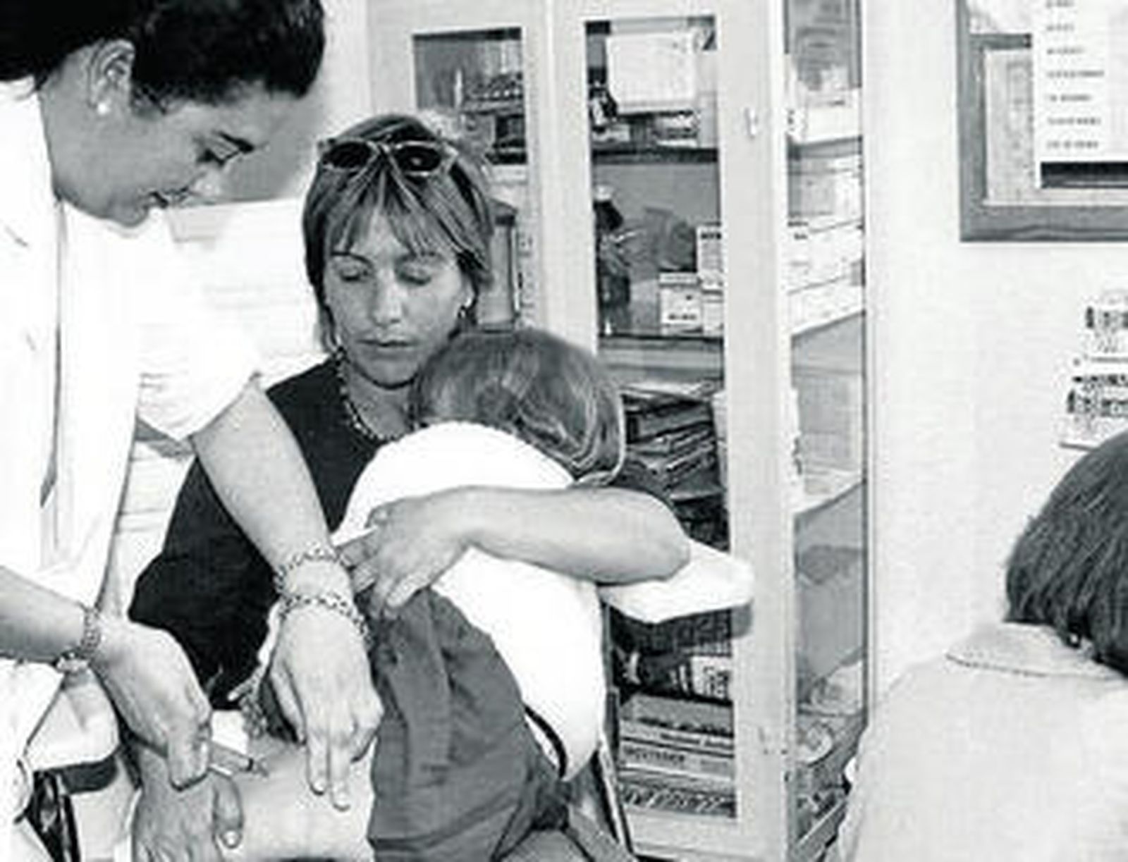 Una enfermera pone una vacuna contra la meningitis a una niña.