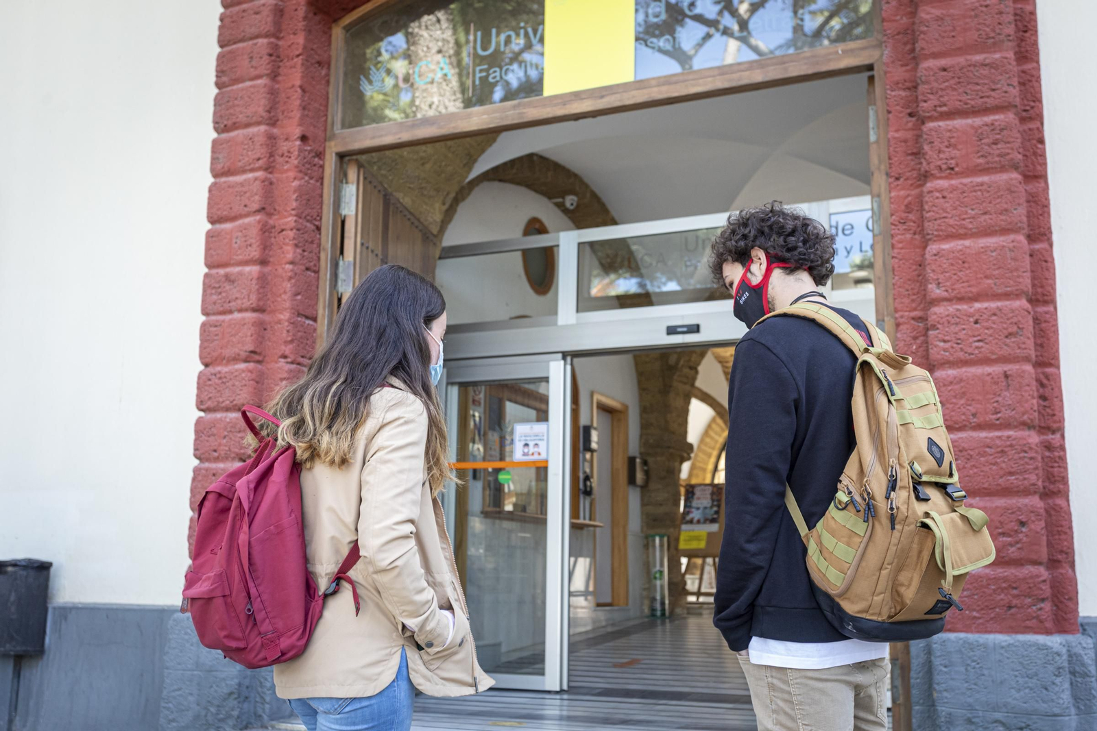 Dos estudiantes en el exterior de la Facultad de Filosofía y Letras.