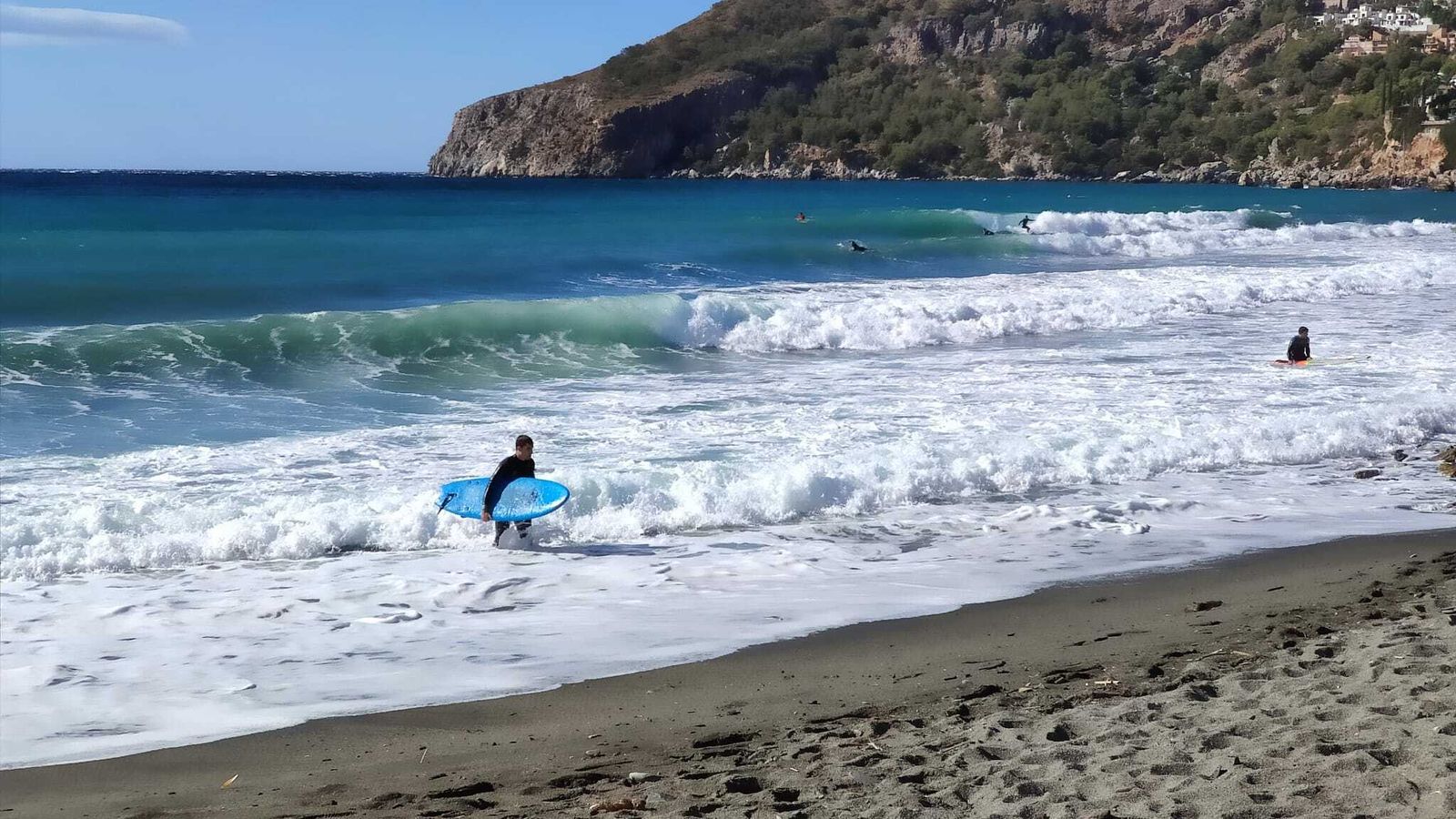 Surfistas en la bocana del río Jate.