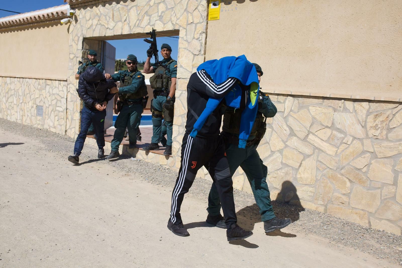 Uno de los detenidos sale escoltado por la Guardia Civil de un inmueble de Trebujena.