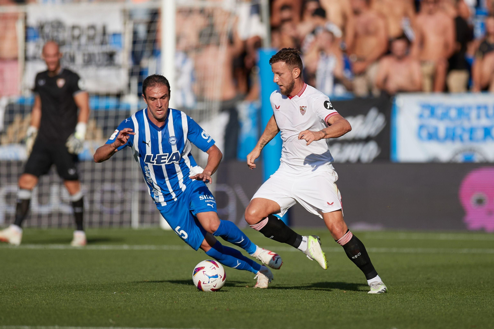 Rakitic intenta conducir hostigado por Kike García.