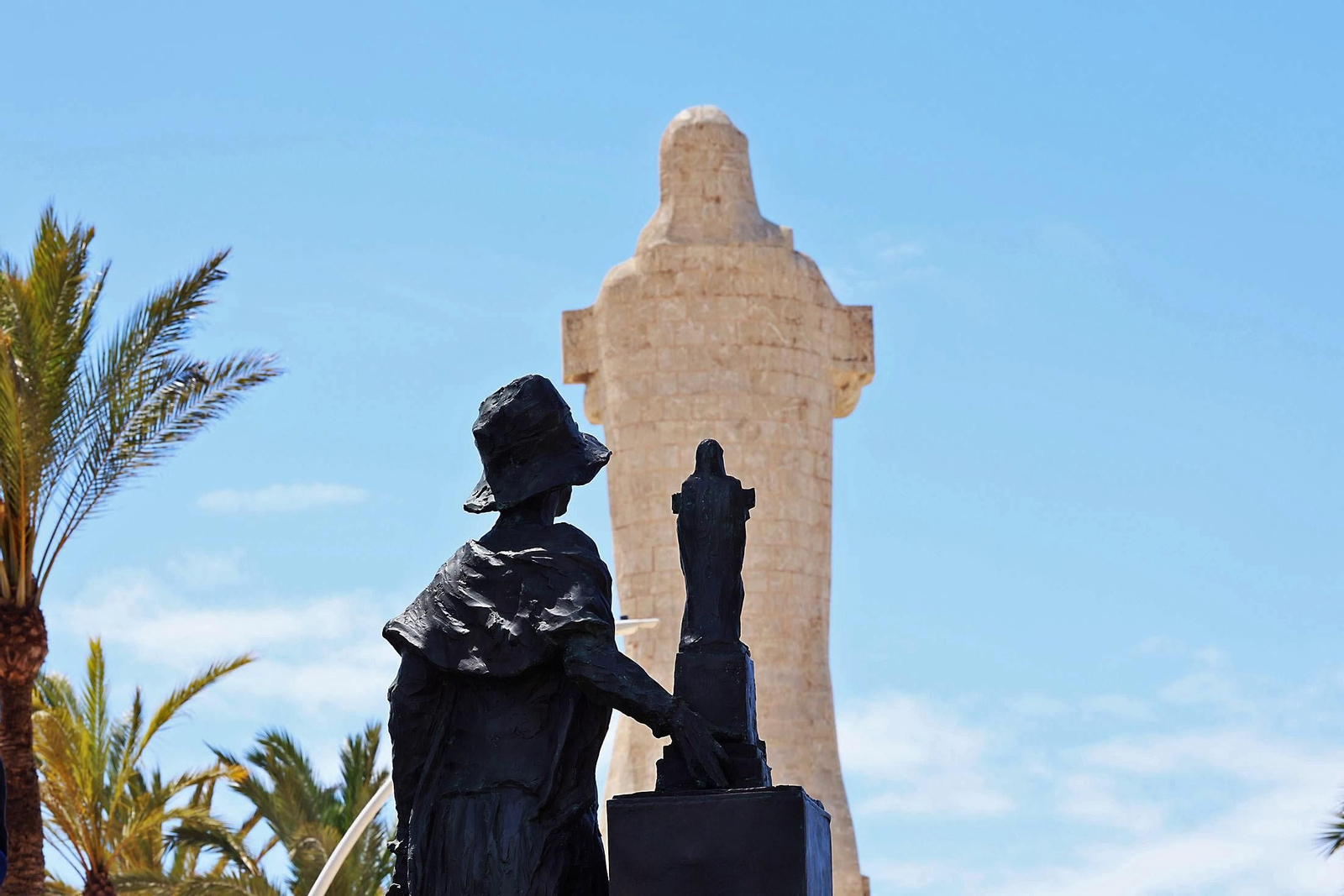 La escultura de Miss Whitney, de espaldas, ante el Monumento a Colón en la Punta del Sebo en Huelva.
