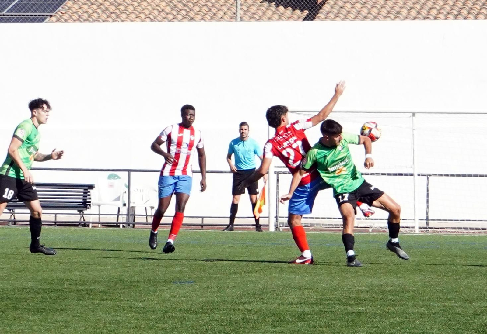 El almeriense Edu Plá pelea por un balón con un jugador del conjunto granadino.