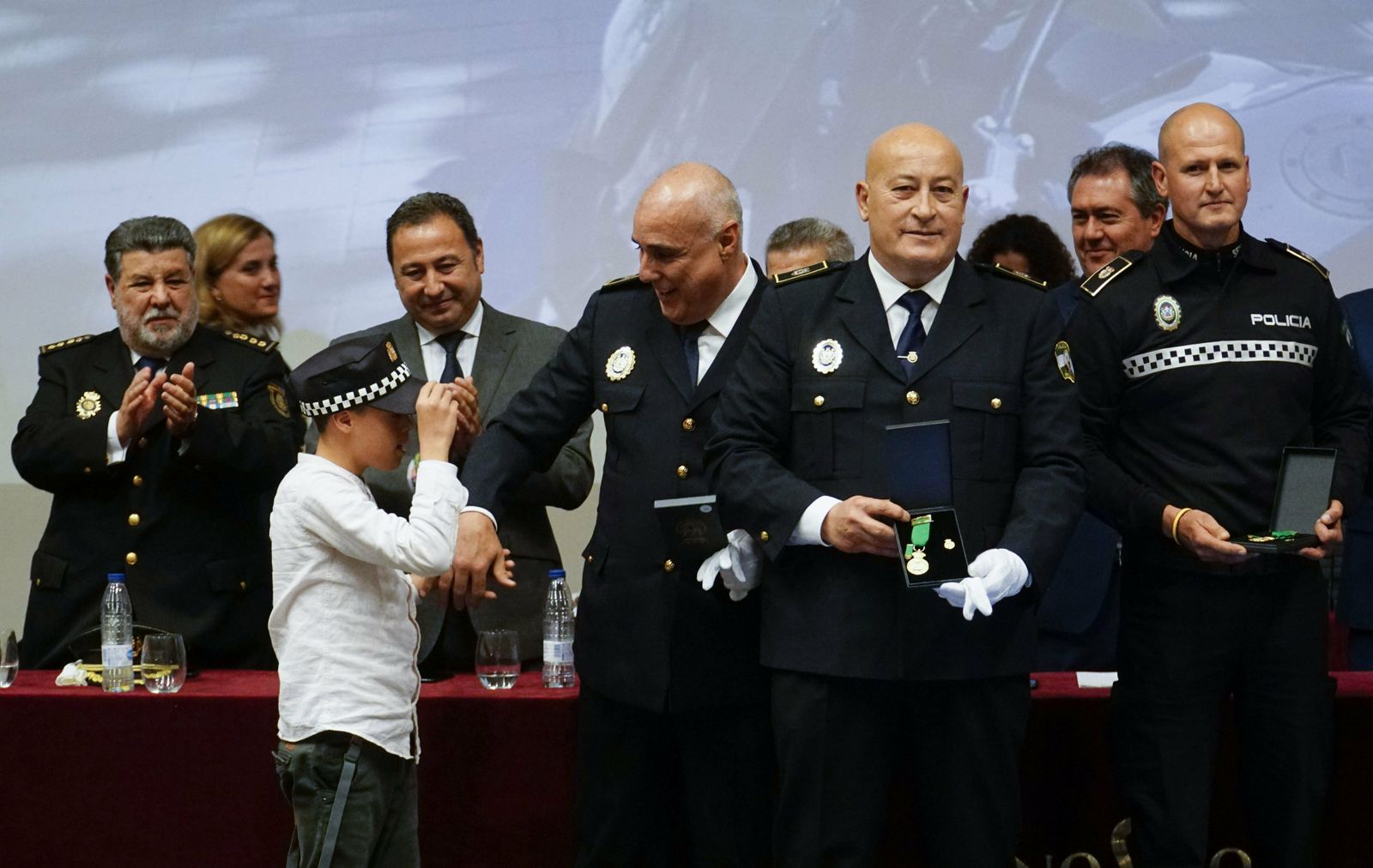 Sebastián Borrás, policía local de Sevilla, con su hijo de la mano.