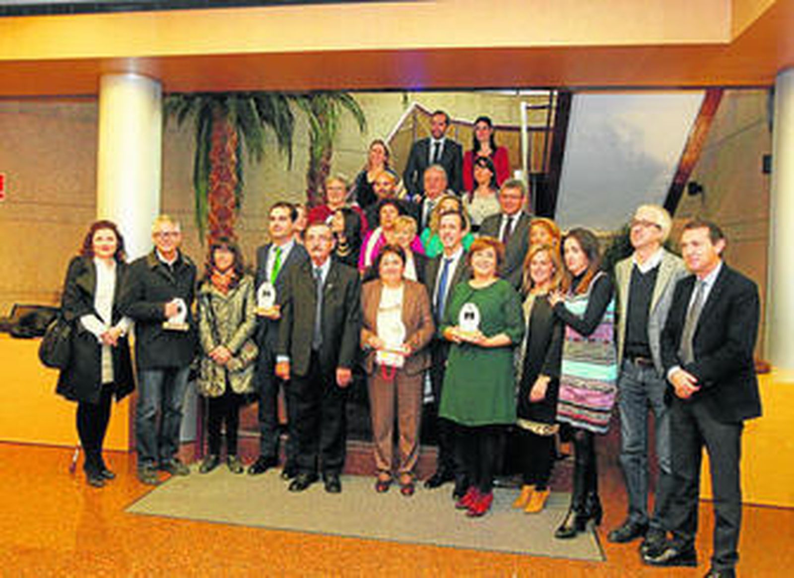 Foto de familia de los representantes de las instituciones, el presidente de Alcer y los galardonados.
