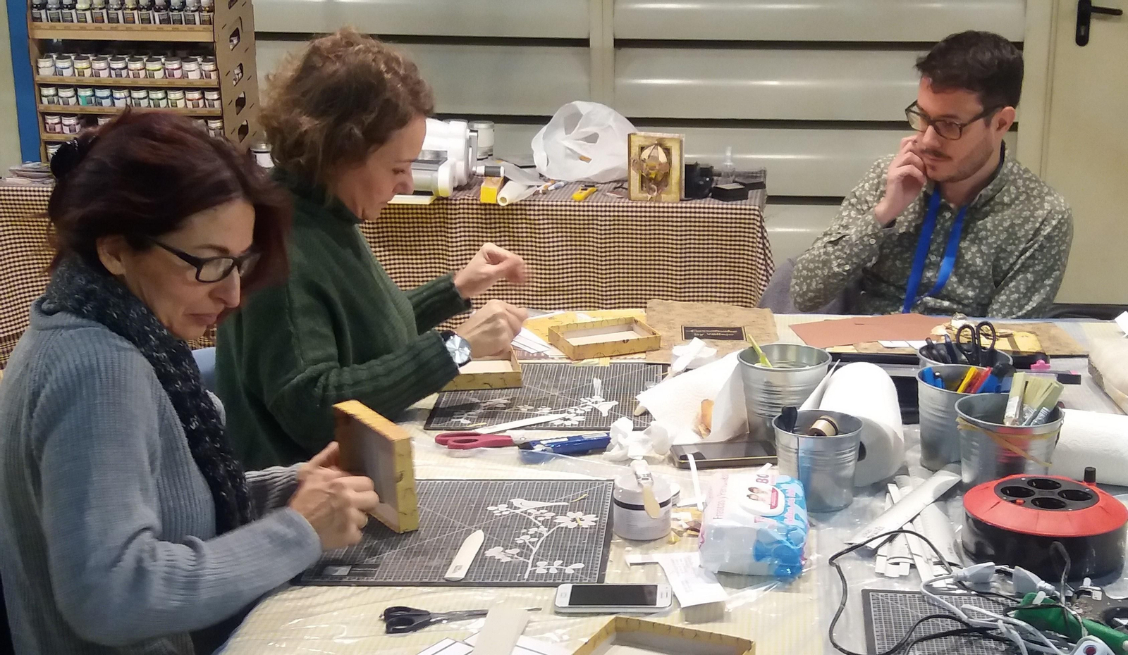 Dos mujeres realizan labores durante el salón de manualidades.
