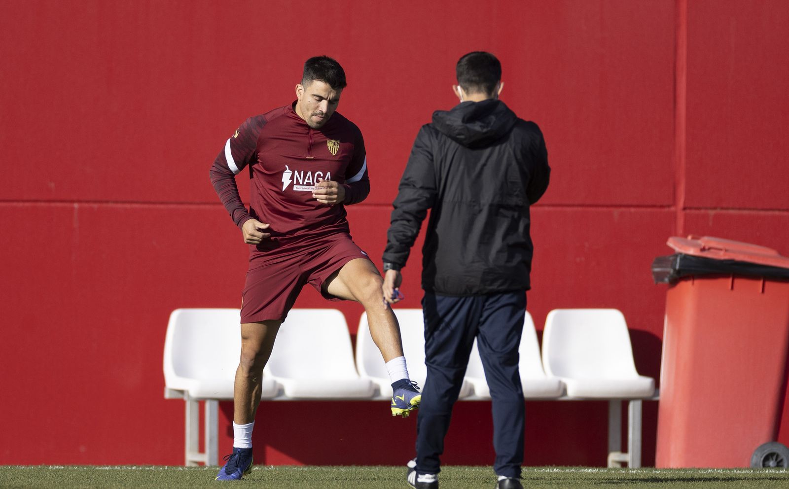 Acuña realiza ejercicios con uno de los preparadores físicos del Sevilla.