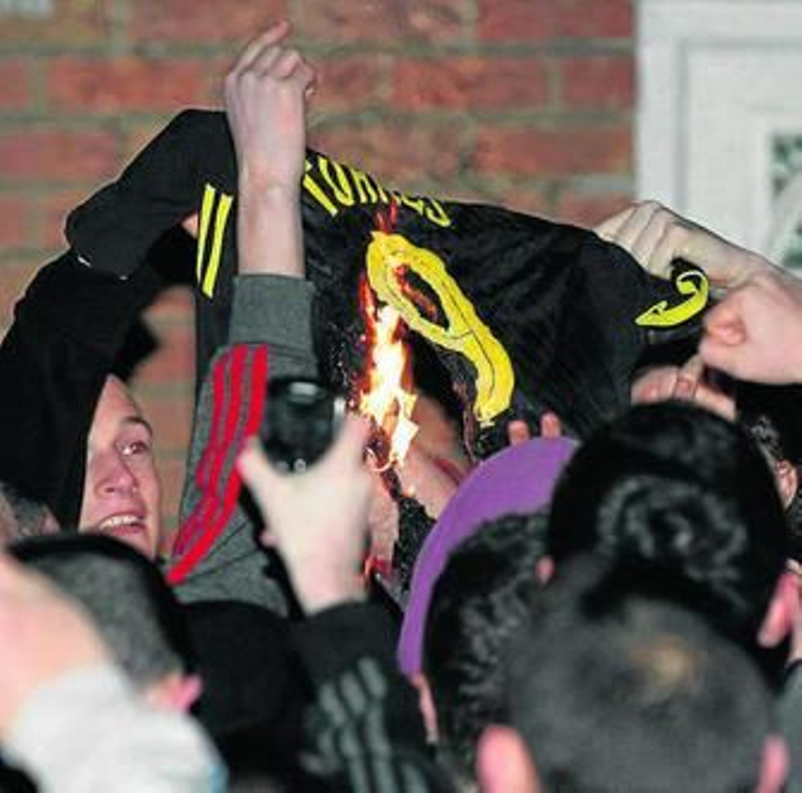 Aficionados del Liverpool queman una camiseta de Torres.