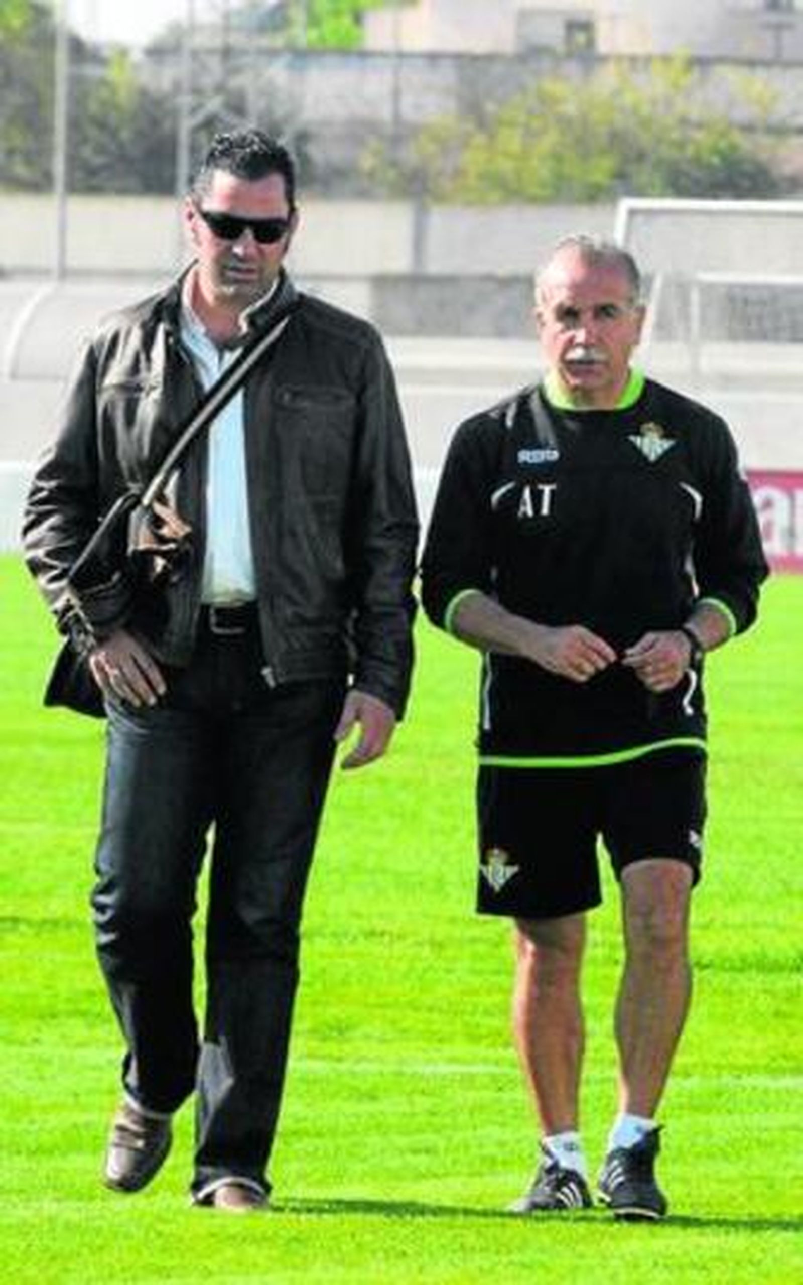 Tapia camina mientras dialoga con Momparlet.