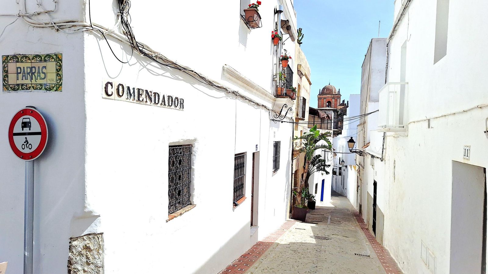 Calle Comendador esquina con Parras. Al fondo la torre-campanario de la iglesia de San Mateo.