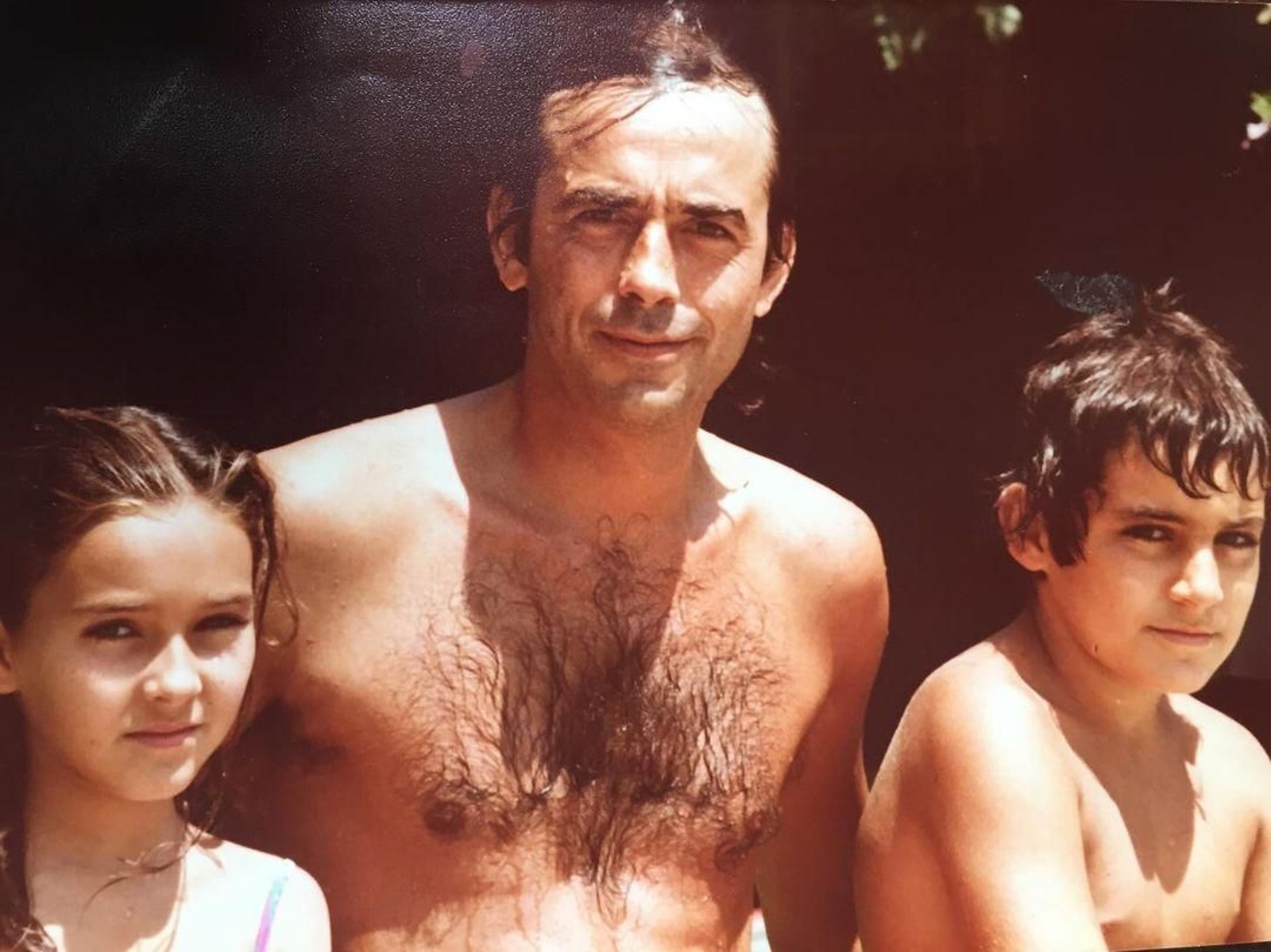 Cristina Garcés y su hermano Andrés, junto a Joan Manuel Serrat, en la piscina del Hotel Reina Cristina de Algeciras.
