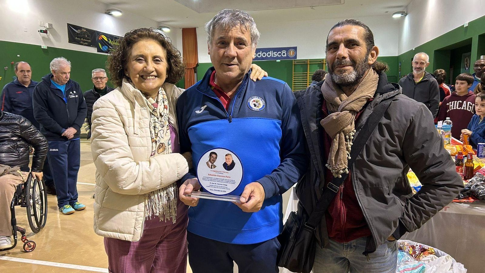 Chano, junto a sus hermanos, Belén y Antonio, con la placa que le entregaron.