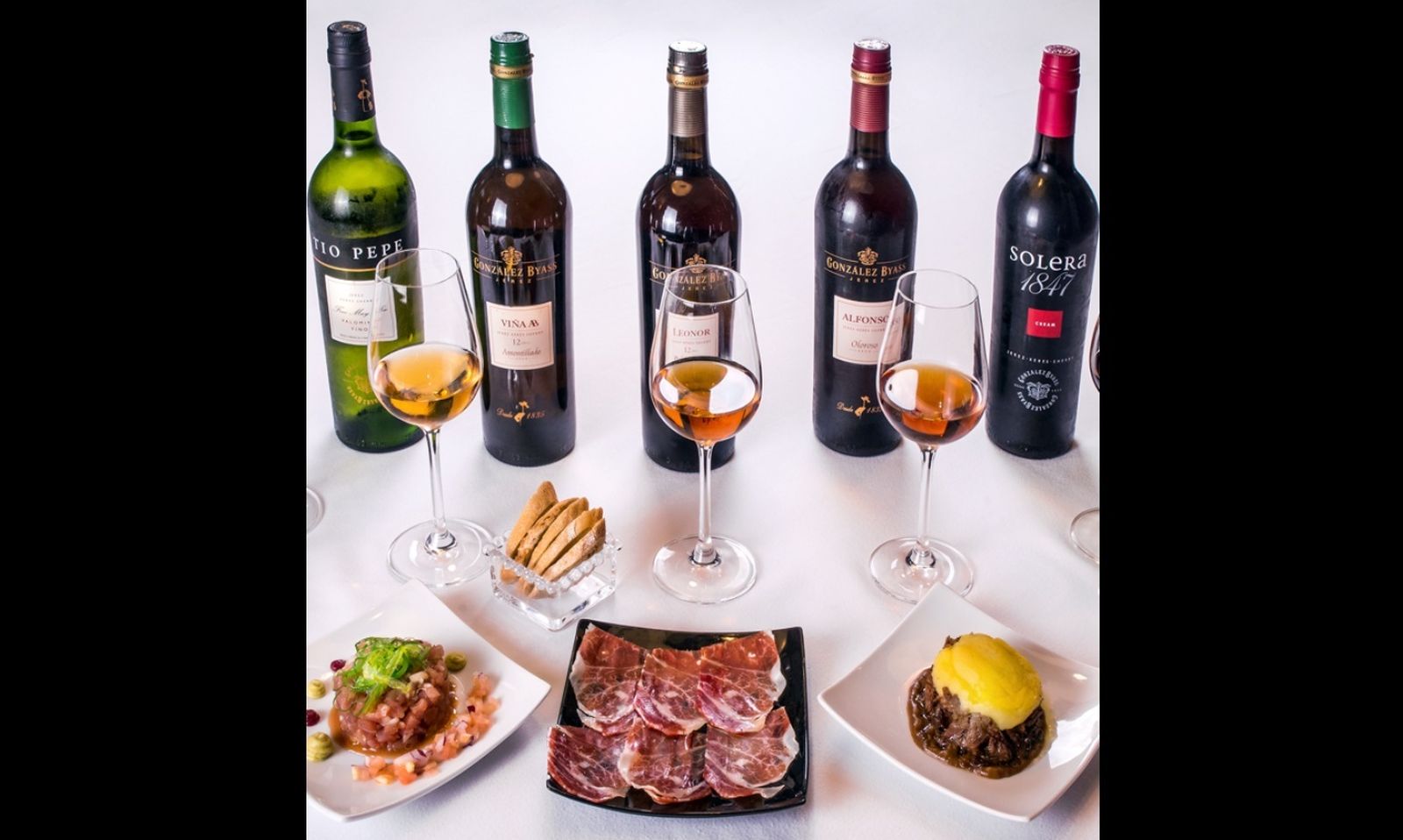 Gama de vinos de Jerez de González Byass junto a unas tapas.