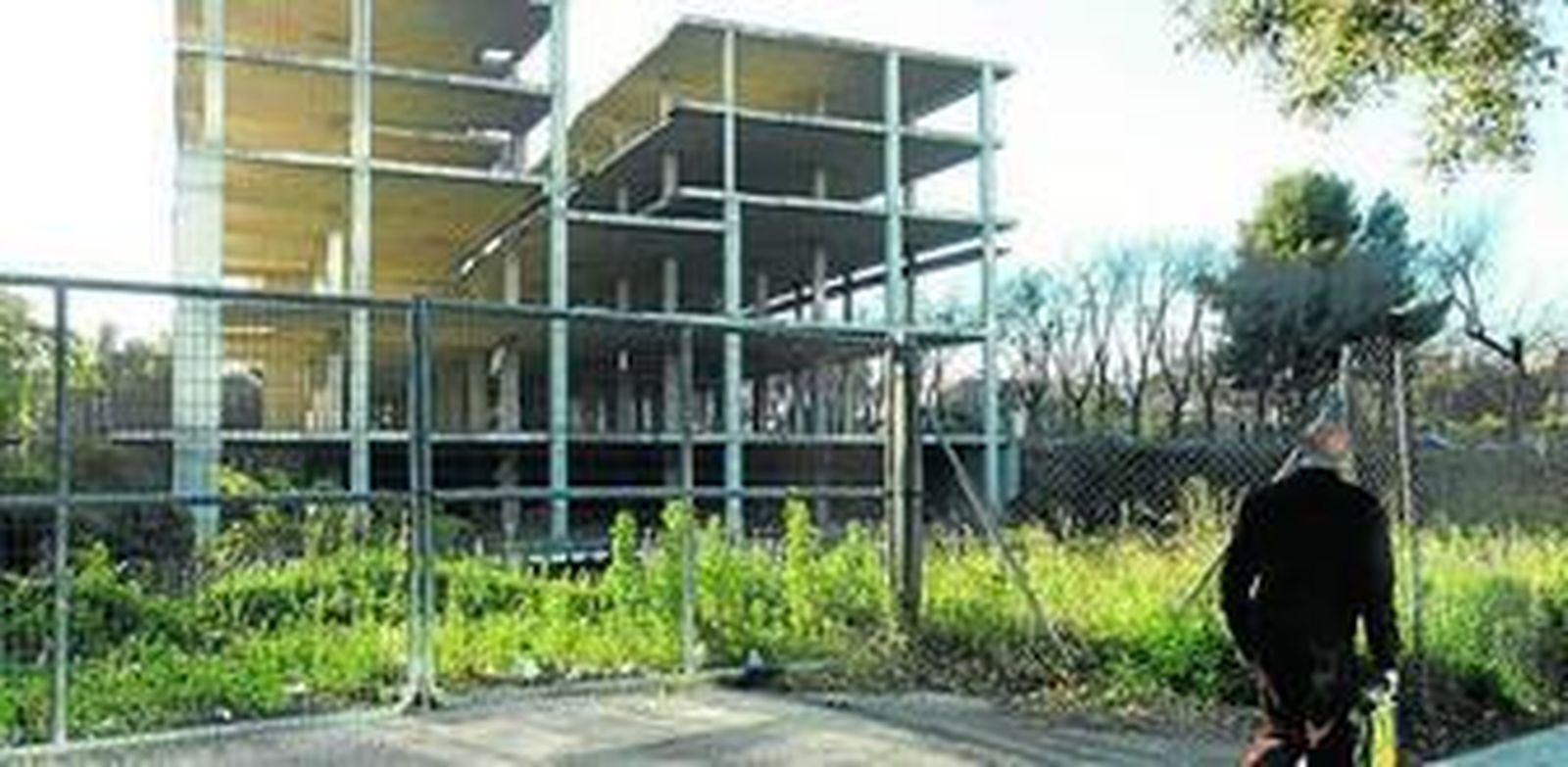 Un hombre pasa ante el esqueleto del edificio, en Alcalde Luis Uruñuela.
