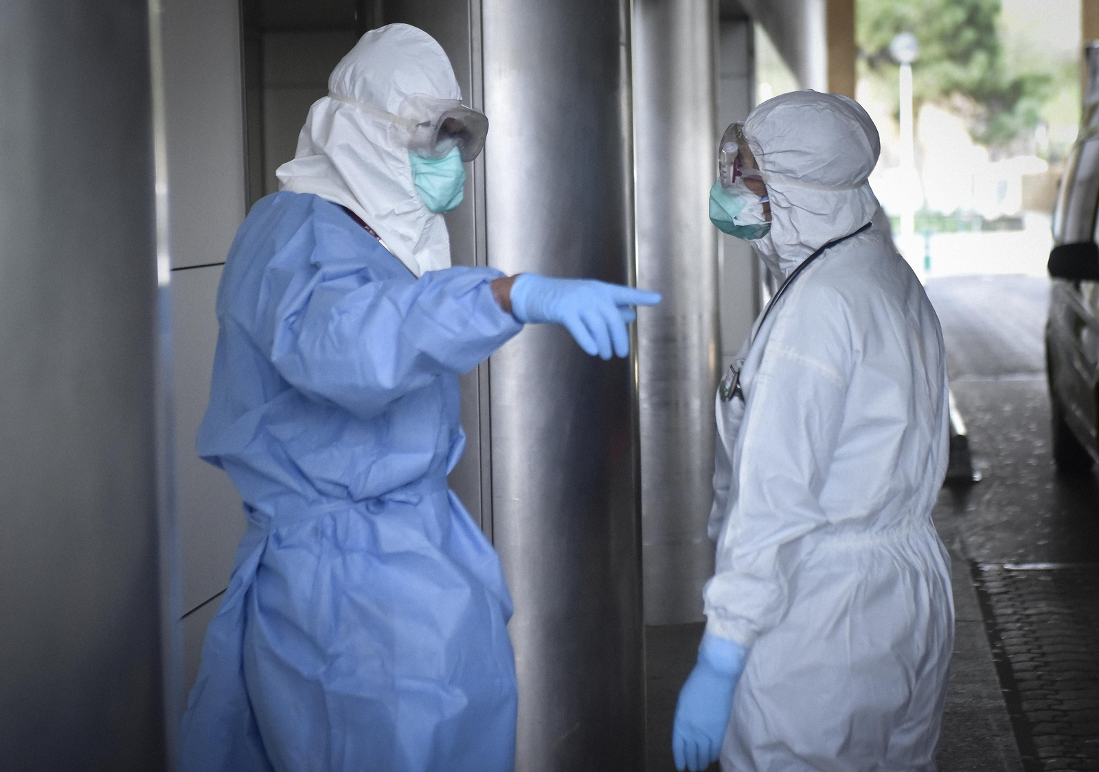 Médicos ataviados con material de protección en la puerta del hospital.
