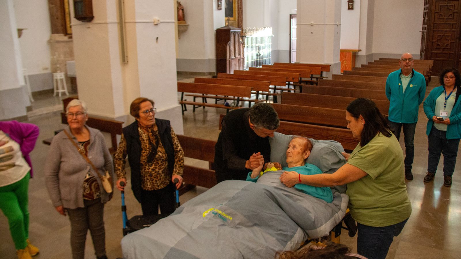 Josefa con su hija y el párroco de la Iglesia de Vélez de Benaudalla rezando a San Antonio