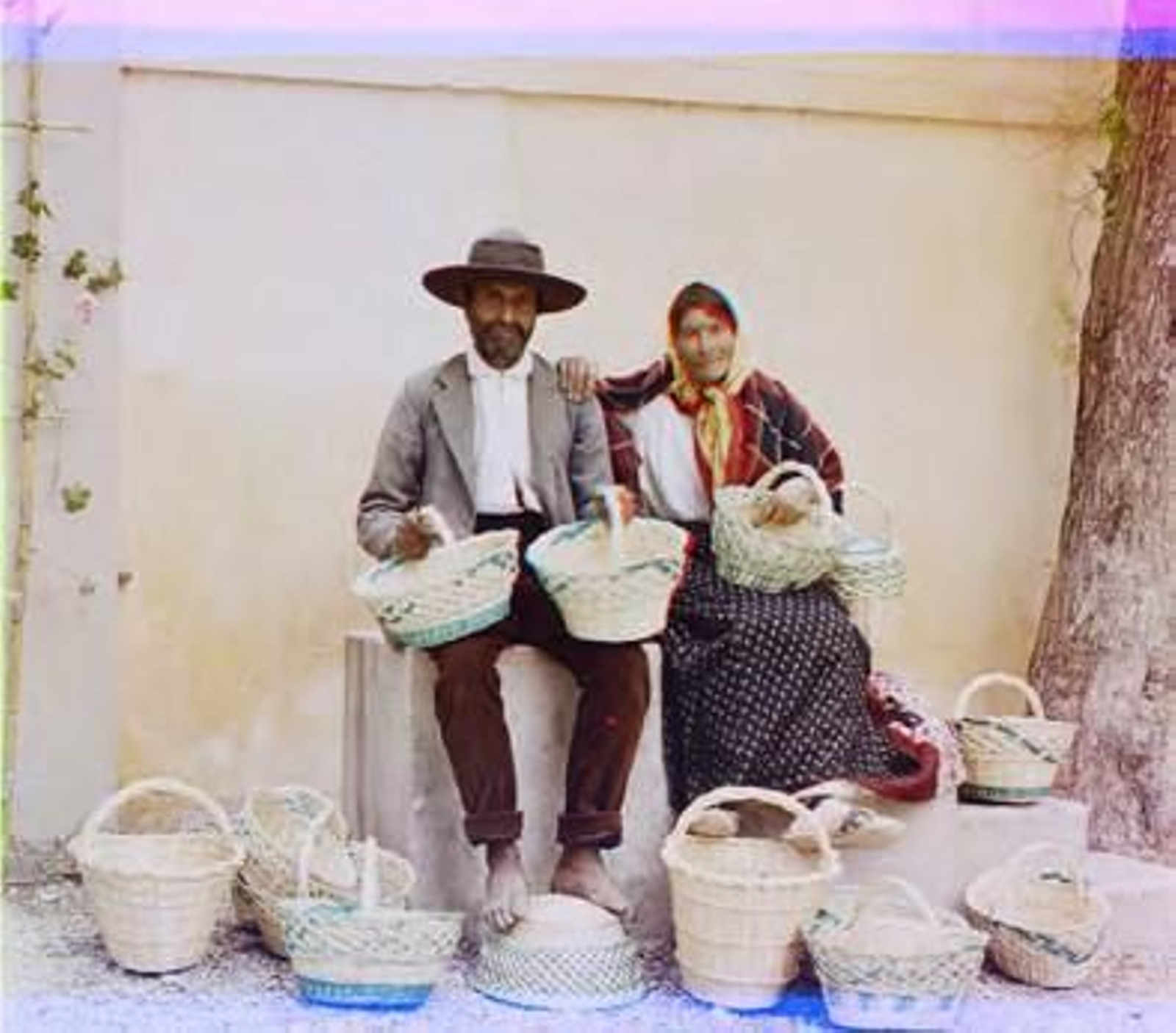 'An unidentified man a woman, sitting on horse mounting blocks outside the Mount'.
